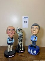 Front view of three bobbleheads