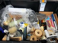 Bin with masking paper rolls, roller covers, wire brushes, scrapers and accessories