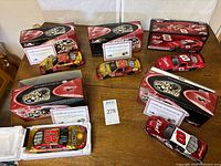 Overall lot showing five cars with boxes and COAs