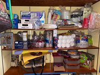 Overall view of three shelves filled with disposable picnic items