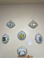 Front view of all six porcelain molds hanging on wall