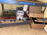 Shelf with induction cooktop, water filter jug, boxes and packaging