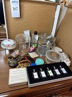 Overview of lot showing perfume sampler, compact, glass jars, acrylic organizers, porcelain box and accessories