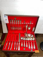 Open chest showing full flatware set in red lining