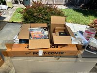 Overall lot on storage chest with boxed items, Poly-Cover visible