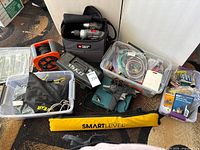 Overview of lot showing SmartLevel sleeve, extension cord reel, Porter-Cable screwdrivers in bag, bins with hardware