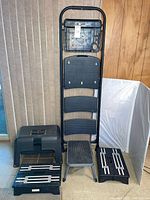 All five items grouped: ladder, Rubbermaid tool box step, grey stool, two black stools
