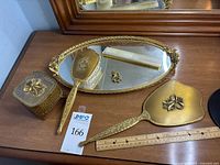 Full set on dresser showing tray, brush, comb, mirror, box
