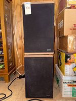 Front view of two stacked KLM speakers with black grills