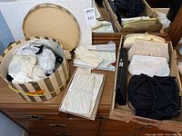 Overview of lot showing hat box, gloves and multiple clutches