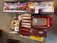 Group shot showing North Star Express set, Orchard Supply Hardware boxcar, track pack, and stack of Tyco/Atlas HO boxes