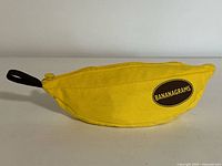 Yellow banana-shaped pouch with zipper and Bananagrams logo