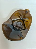 Top angled view of the flattened amber glass bottle tray showing logo and overall shape