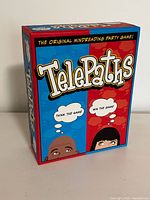 Box front of Telepaths board game by Outset Media showing colorful design and game title