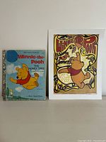 Vintage Winnie the Pooh The Honey Tree book alongside a stylized Winnie the Pooh poster.