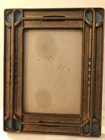 Full view of rectangular brass frame with blue insets