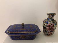 Trinket box with lid and small vase side by side