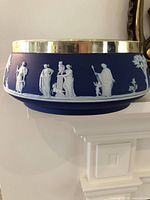 Front view showing entire Wedgwood blue jasperware bowl with silver rim and classical relief figures