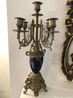 Full view of brass and marble five-arm candelabra