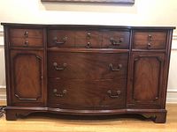 Front view showing drawers, cabinets, brass hardware