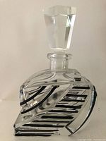 Front view showing geometric cut crystal body with black enamel stripes and faceted stopper