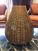 Front view of ribbed glass vase showing color and texture