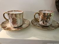 Front view of both cup and saucer sets