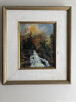 Framed oil painting on wall