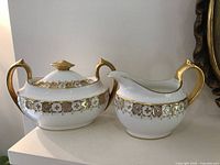 Sugar bowl and creamer side by side showing pattern and form