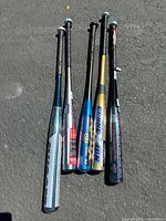 Five aluminum baseball bats arranged side by side showing full length, revealing colors and brand logos.