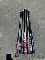 Five aluminum baseball bats bundled together showing grips and barrel ends, displaying model graphics and branding
