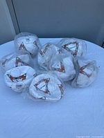 Group of eight white soccer balls in original plastic packaging with visible Spalding triangular logo.