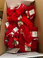Box filled with over 40 pairs of solid red athletic socks, all tagged and new.