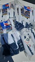 Photo showing multiple packages of new navy and black stirrup socks bundled together in plastic packaging, with Ribbed brand visible on tags.