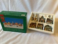 Box front and open styrofoam tray showing houses and wiring