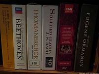 Spine view of six CD box sets on shelf