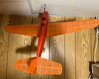 Top view showing red fuselage, orange wings and tail surfaces