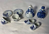 Front view of all eight Delft Blue ceramic pieces