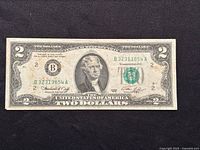 Front side of a 1976 United States two dollar bill banknote showing Thomas Jefferson portrait, serial number, and signatures.