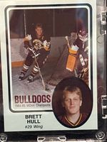 Front side of the 1985 Brett Hull hockey card showing action and portrait images of player in Minnesota-Duluth Bulldogs uniform.