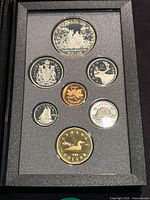 Photo of six proof coins mounted in black foam case, showing full set layout
