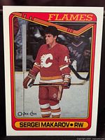 Front of 1990-91 O-Pee-Chee Sergei Makarov hockey card showing player in Calgary Flames uniform with border and card number 60.