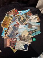 Pile of vintage postcards fanned out showing various Canadian scenes including buildings, nature, and water views