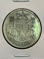 Obverse of the 1941 Canadian half dollar showing the coat of arms and denomination.