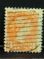 Front of a 3 Cent Queen Victoria used Canadian stamp, orange color, showing cancellation marks.