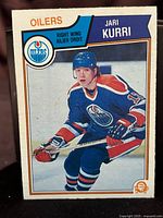 Front side of 1983-84 O-Pee-Chee Jari Kurri hockey card showing player in Oilers uniform with card branding and player name.