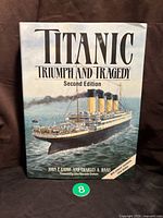 Front cover of the Titanic book showing detailed illustration of the Titanic ship and title text.