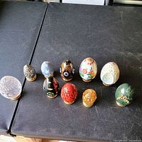 Group shot of all ten eggs on gold-tone stands