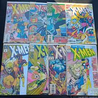 Group shot of all eight bagged comics showing cover art and most issue numbers