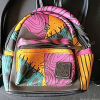 Front view showing full backpack, plaque and patchwork design